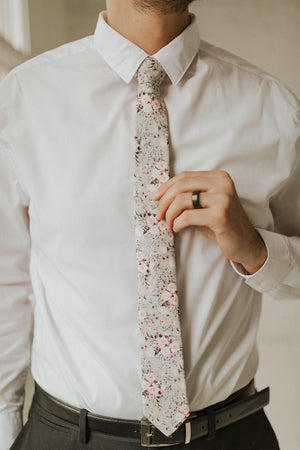 Sweet Pea tie worn with a white shirt and black pants.
