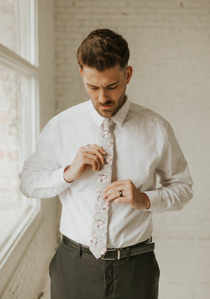 Sweet Pea tie worn with a white shirt and black pants.