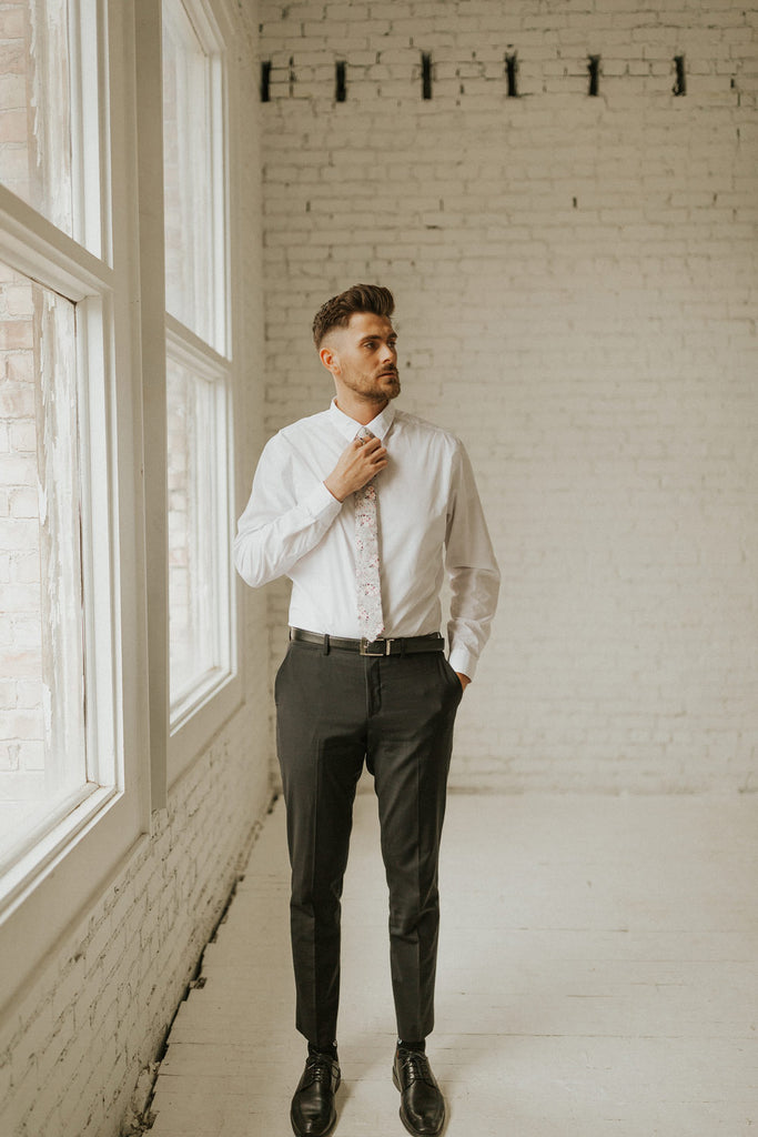 Sweet Pea tie worn with a white shirt and black pants, black shoes.