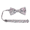 Sweet Pea Pre-Tied Bow Tie with adjustable neck strap. Light gray background with groups of white, blush and burgundy flowers and black and gray stems and leaves.