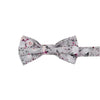 Sweet Pea Pre-Tied Bow Tie. Light gray background with groups of white, blush and burgundy flowers and black and gray stems and leaves.