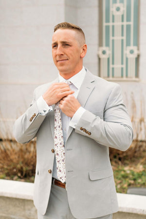 Sweetly Picked tie worn with a white shirt, brown belt and light gray suit.