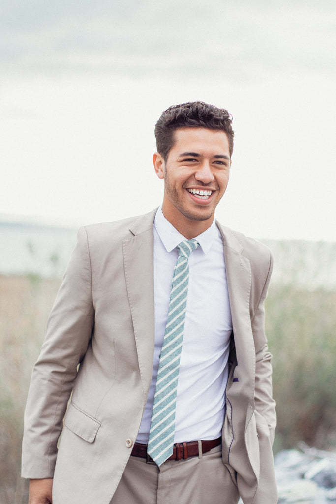 Ranger tie worn with a white shirt and tan suit.