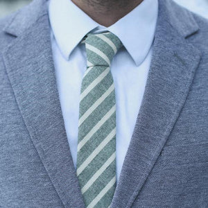 Ranger tie worn with a white shirt and gray suit jacket.