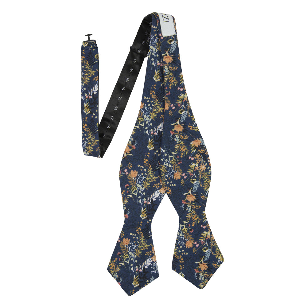 Tiger Lily Self Tie Bow Tie. Dark navy blue background with peach flowers and dusty blue, yellow, green and black leaves.