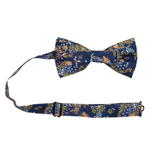 Tiger Lily Pre-Tied Bow Tie with Adjustable Neck Strap. Dark navy blue background with peach flowers and dusty blue, yellow, green and black leaves.