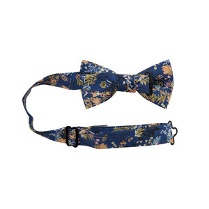 Tiger Lily Pre-Tied Bow Tie with Adjustable Neck Strap. Dark navy blue background with peach flowers and dusty blue, yellow, green and black leaves.