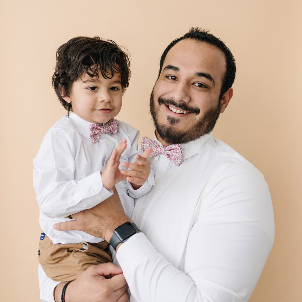 Ventura pre-tied bow ties worn by father and son in white long sleeve shirts.