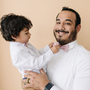 Ventura pre-tied bow ties worn by father and son in white long sleeve shirts.