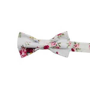 White Floral Pre-Tied Bow Tie. White background with red, pink, blue and gold flowers. Green leaves and stems.