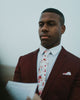 White Floral Pocket Square worn with the matching tie, white shirt and burgundy suit jacket.