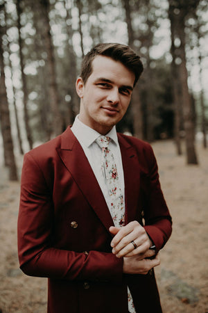 White Floral tie worn with a white shirt and burgundy red suit.