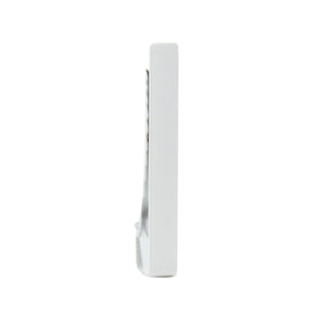 Solid white metal tie bar standing on one end.