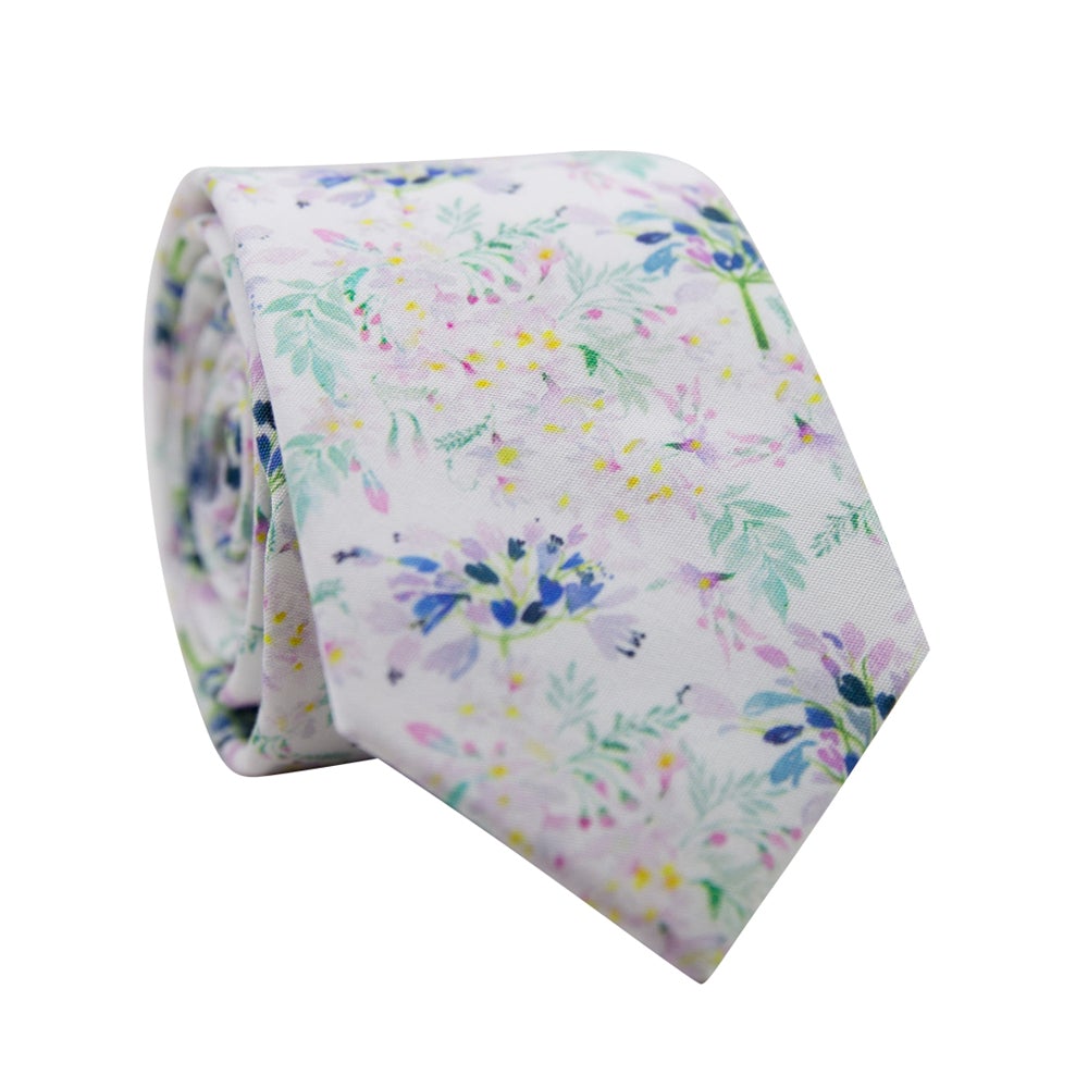 Wild Flower Skinny Tie. White background with small lavender and blue flowers with green and teal stems and tiny yellow leaves.