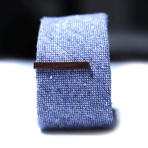 Dark Brown Wood Tie Bar on a textured blue tie. 