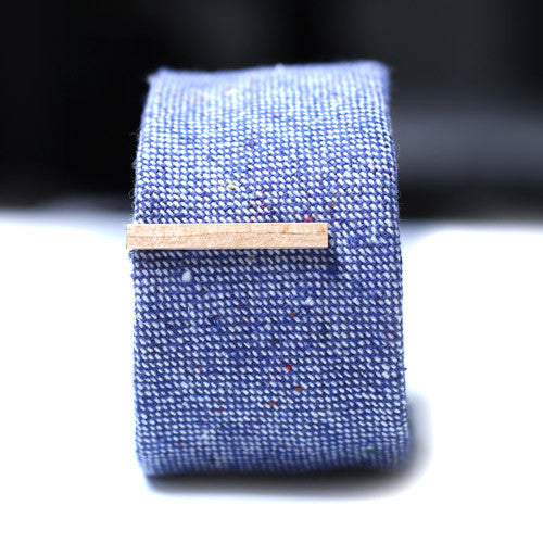 Light Brown Wood Tie Bar on a textured blue tie. 