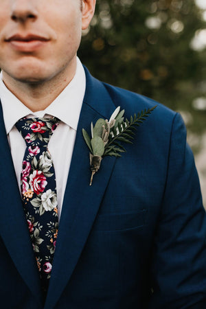 Navy Blue Floral tie worn with a white shirt and navy blue suit jacket.